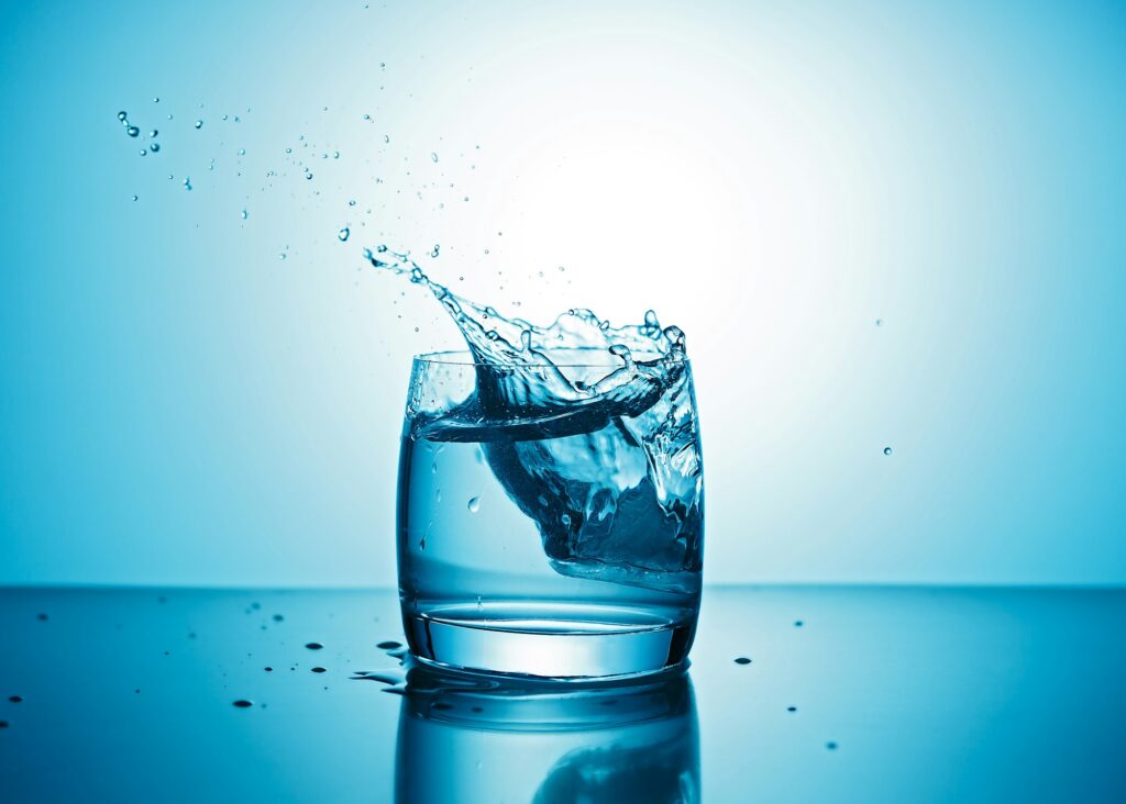 Pure water splashing out of glass